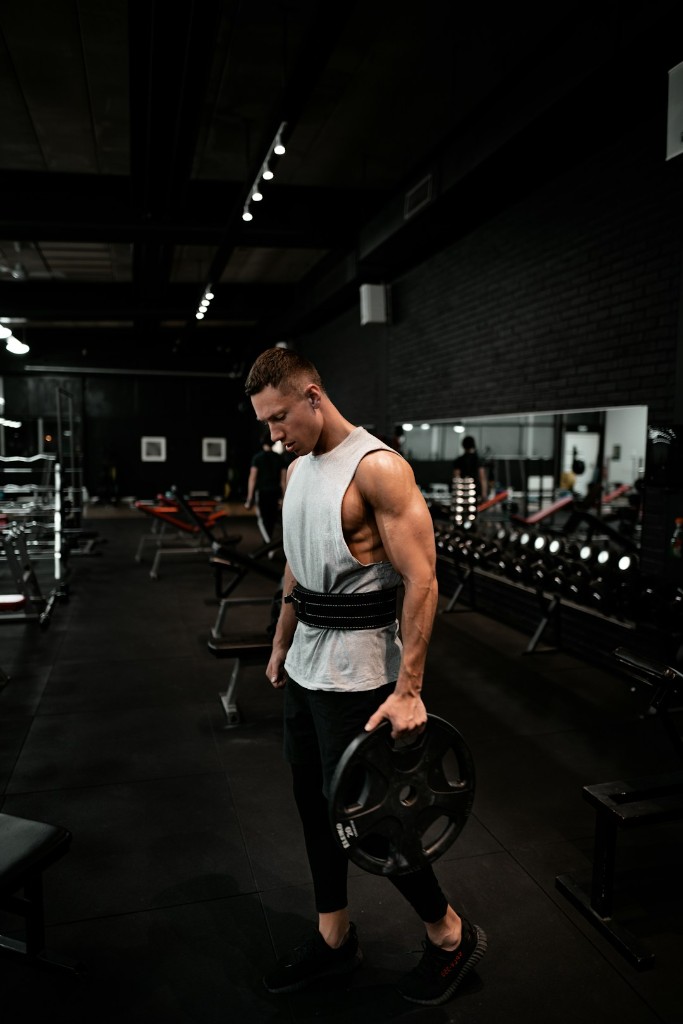 Athlete holding a weight plate in the gym